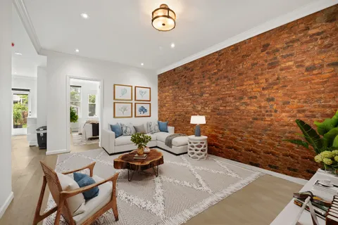 a living room with furniture wooden floor and a rug