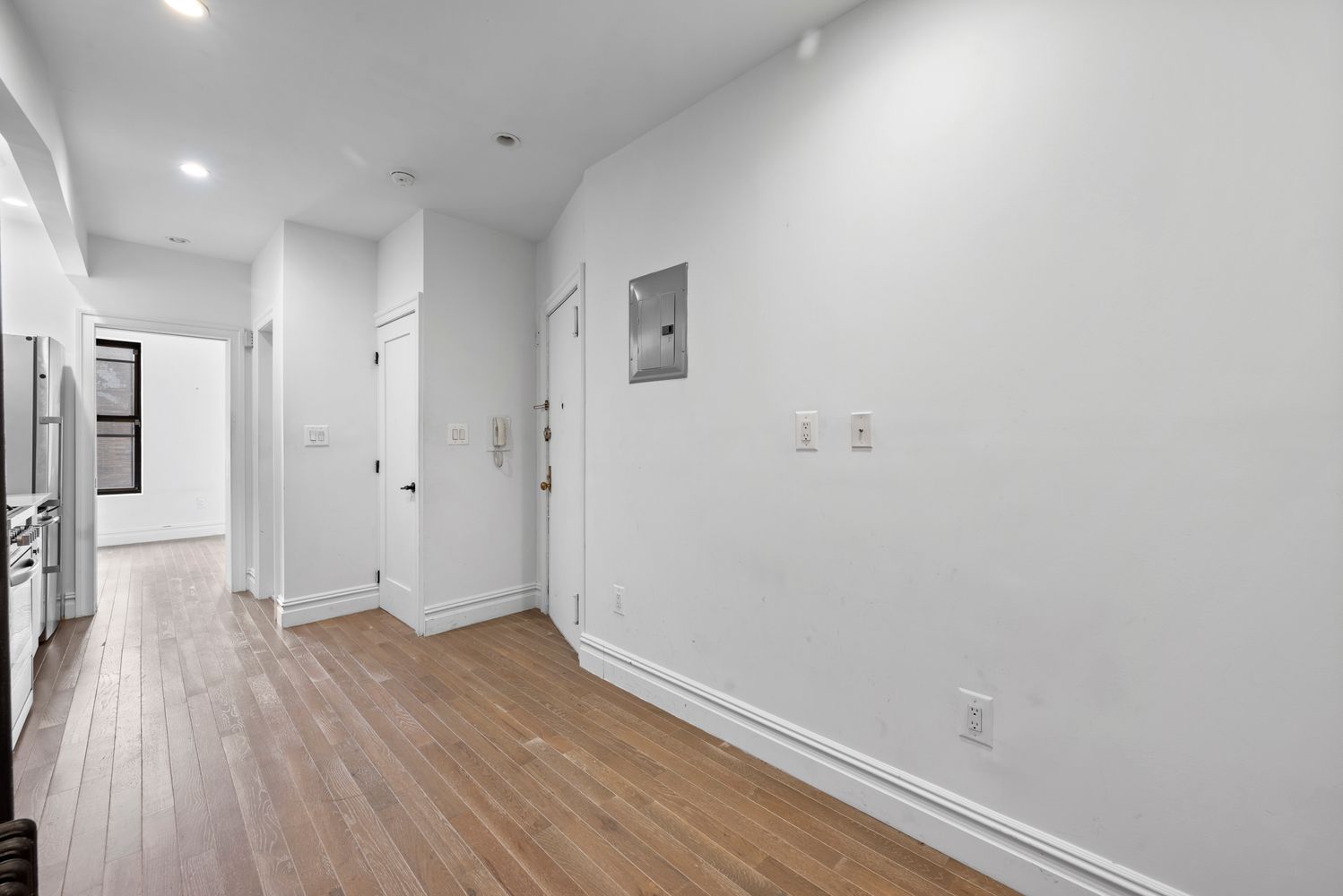 142 Sullivan Street, Unit 14 Manhattan, NY 10012 - Photo 5 of 10 a view of a hallway with wooden floor