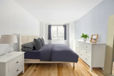 a bedroom with a bed and a dresser