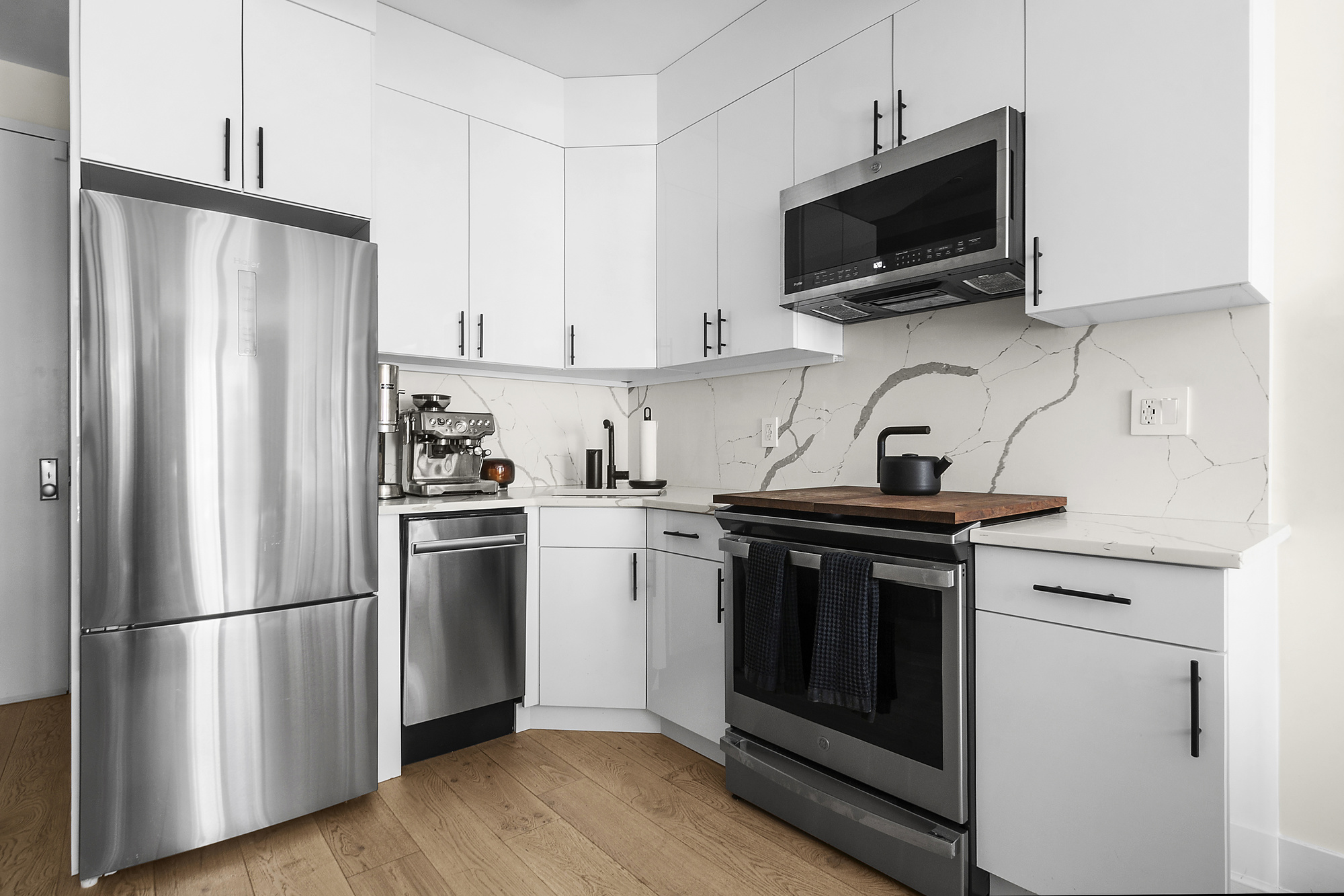 1489 Sterling Place, Unit 2A Brooklyn, NY 11213 - Photo 3 of 9 a kitchen with stainless steel appliances a refrigerator stove and microwave