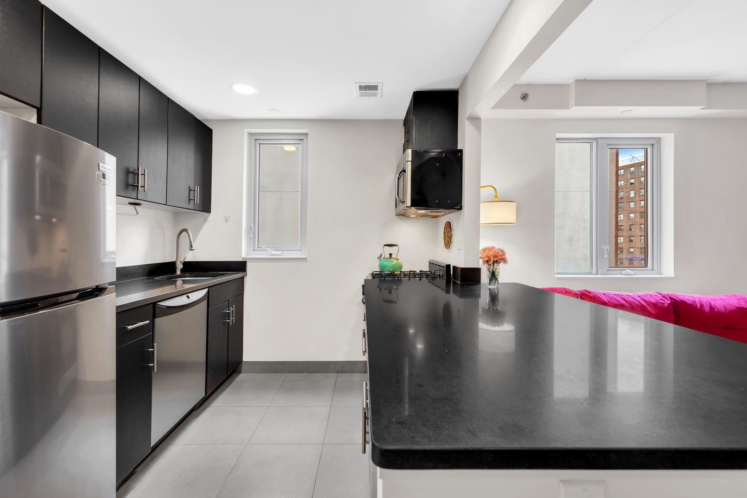1810 3rd Avenue, Unit A7C Manhattan, NY 10029 - Photo 3 of 12 a kitchen with stainless steel appliances granite countertop a refrigerator a stove and a sink with wooden floor