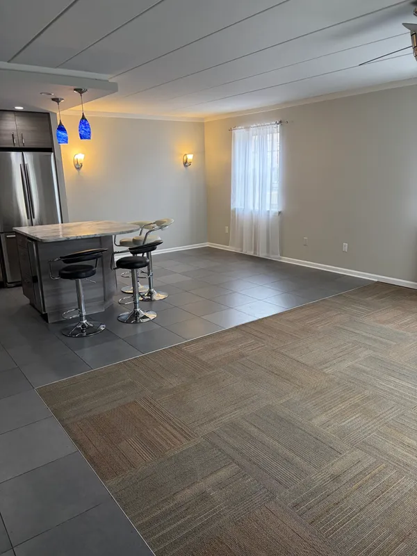 a kitchen with a sink cabinets and wooden floor