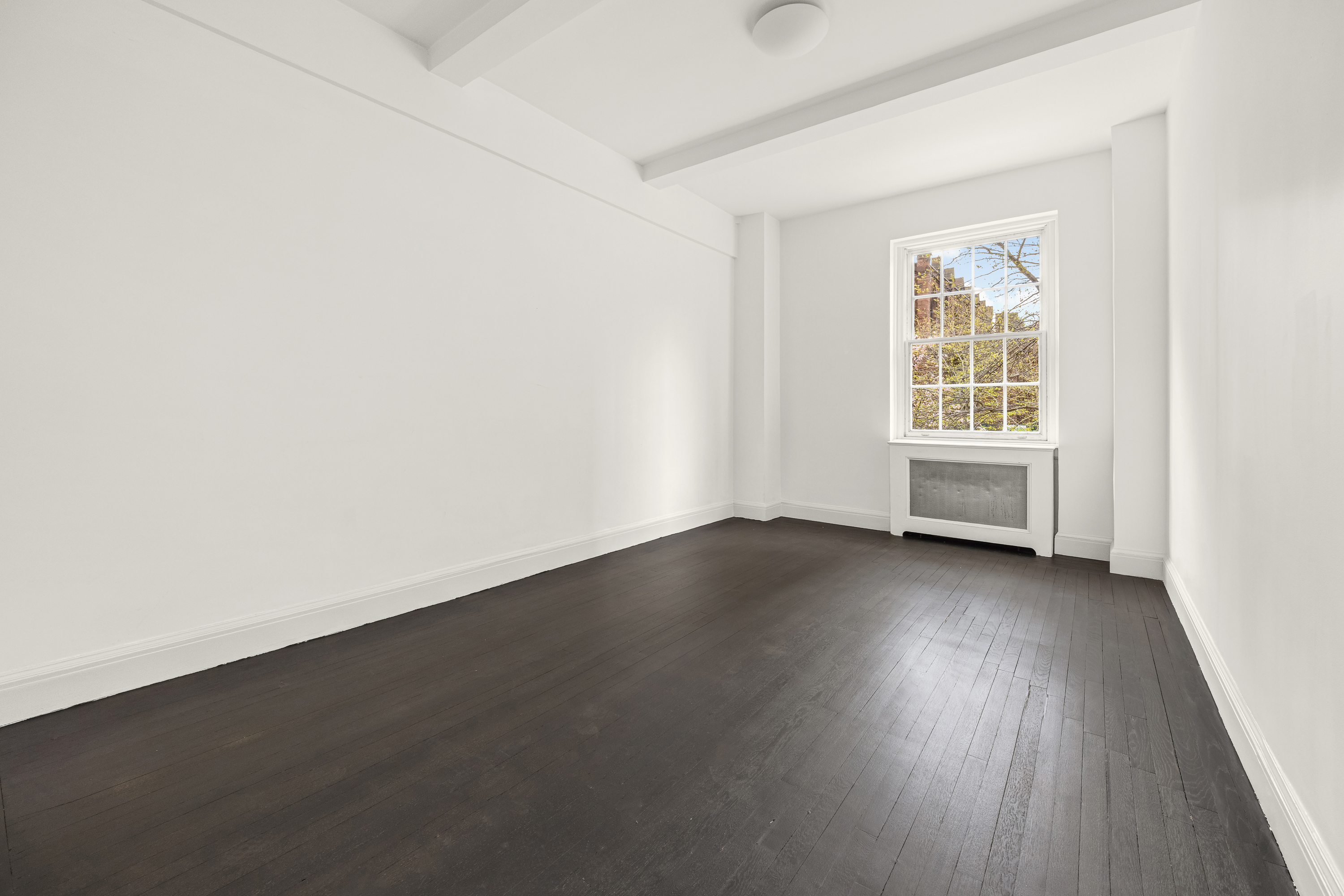 39 5th Avenue, Unit 2B Manhattan, NY 10003 - Photo 4 of 10 an empty room with wooden floor and windows