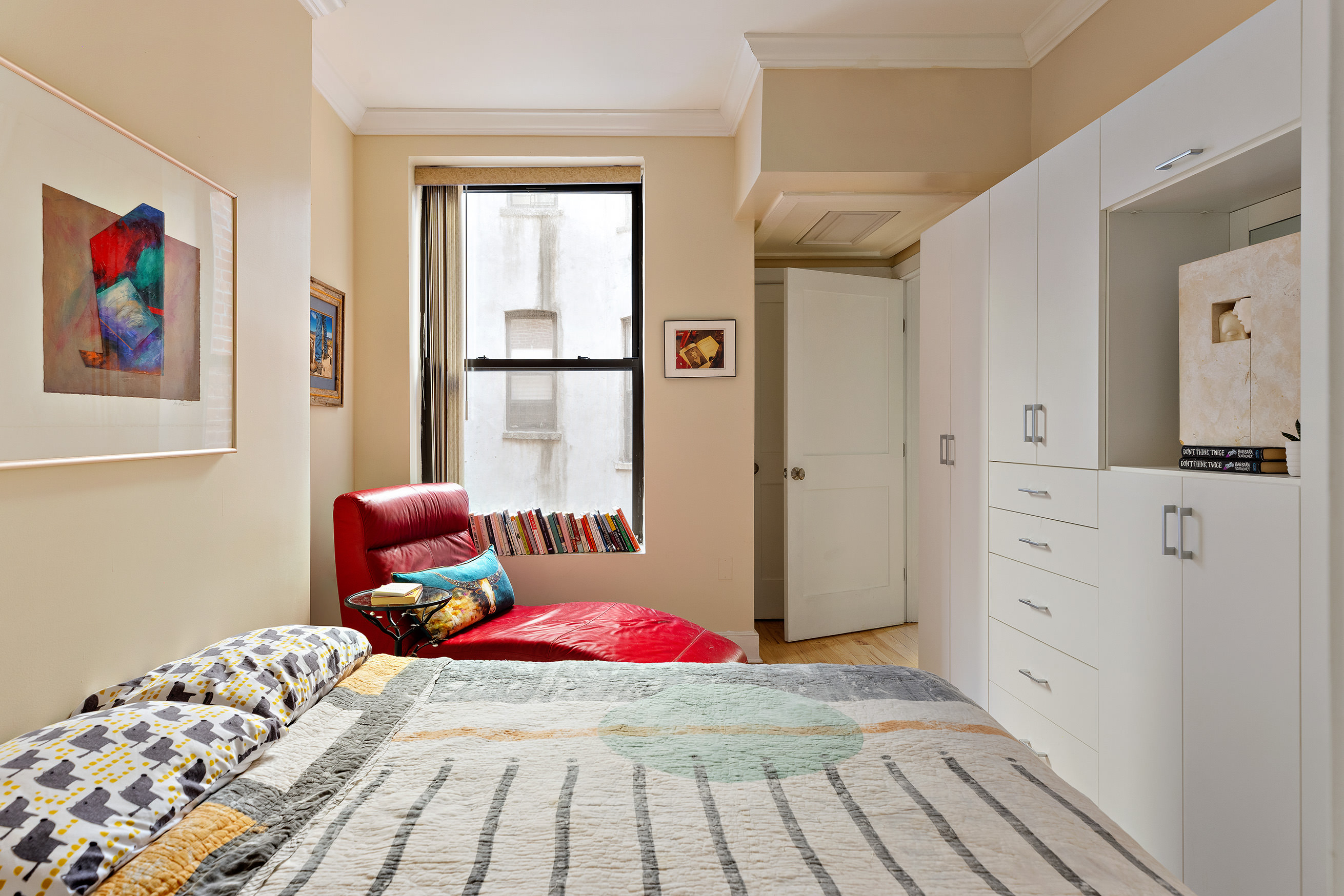 555 Lenox Avenue, Unit 3C Manhattan, NY 10030 - Photo 3 of 7 a bedroom with a bed and a painting on the wall