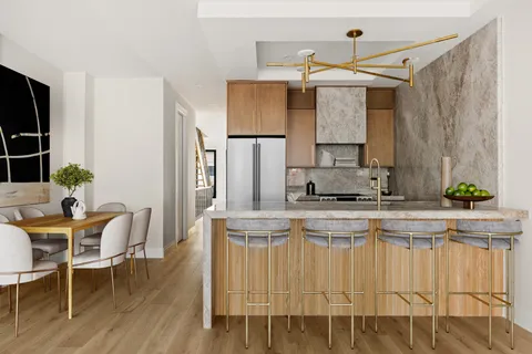 a kitchen with stainless steel appliances granite countertop a white table chairs and a refrigerator