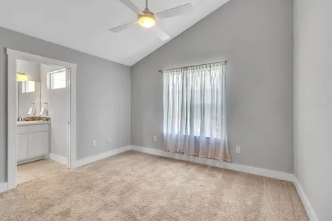 an empty room with windows and cabinet
