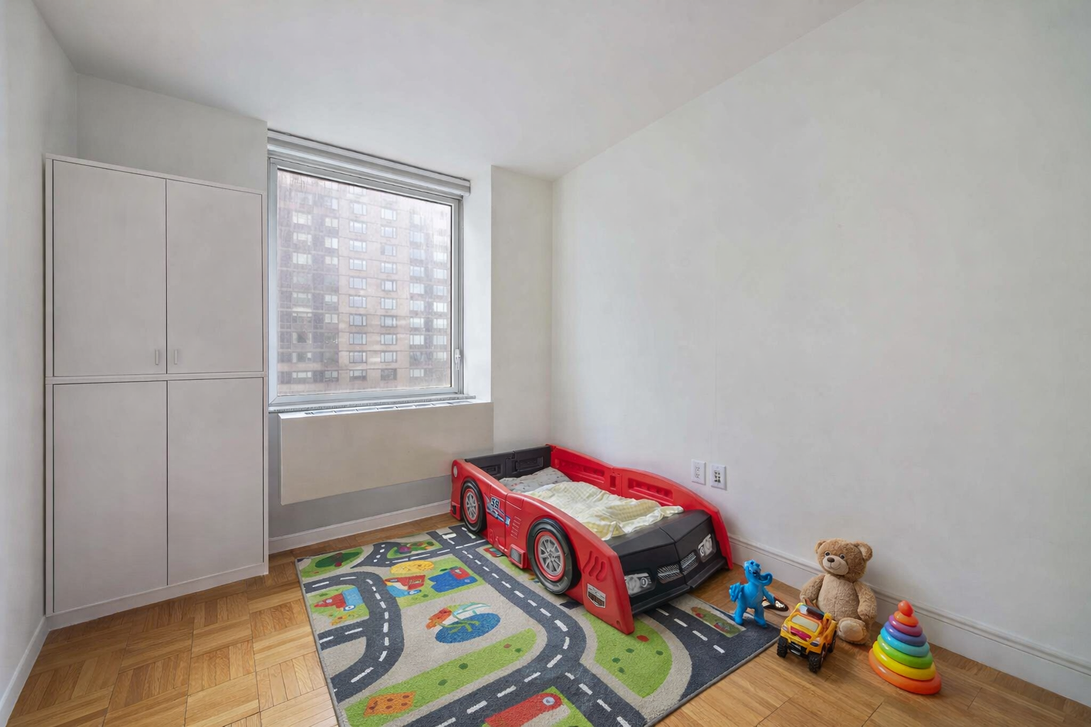 215-217 East 96th Street, Unit 26F Manhattan, NY 10128 - Photo 6 of 19 a bedroom with a bed and a window