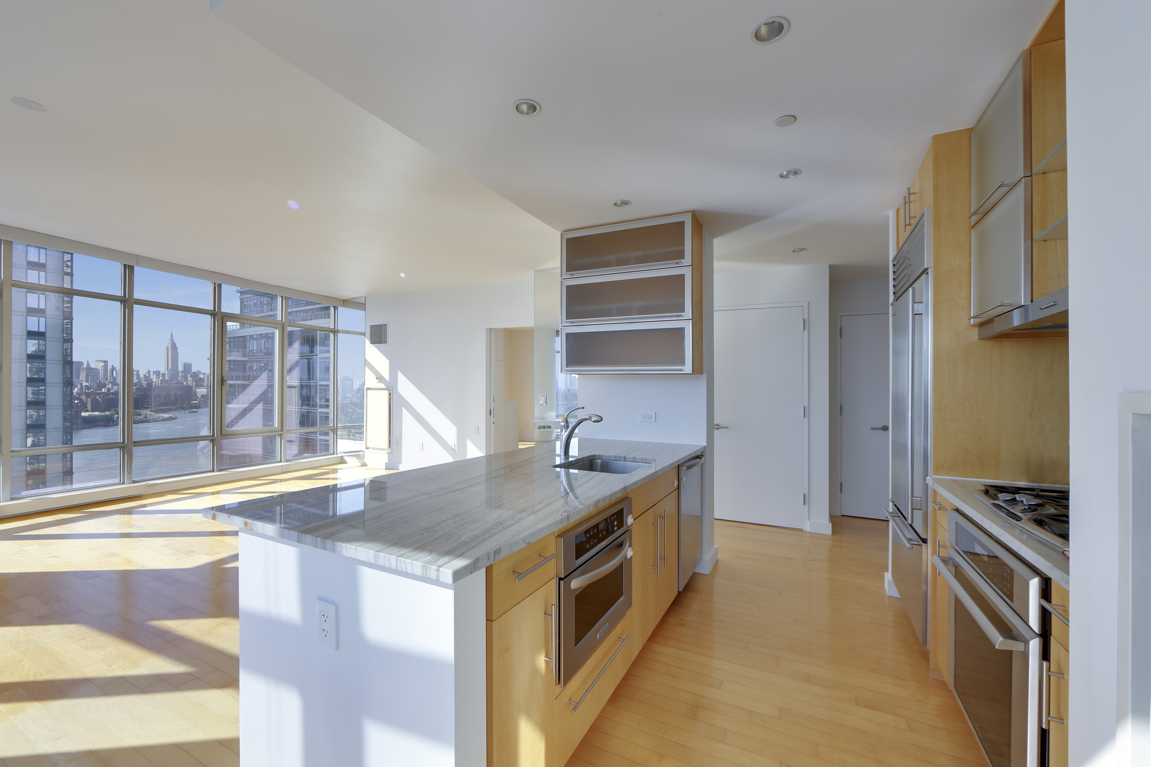 1 Northside Piers, Unit 25D Brooklyn, NY 11249 - Photo 6 of 19 a kitchen with counter top space and stainless steel appliances