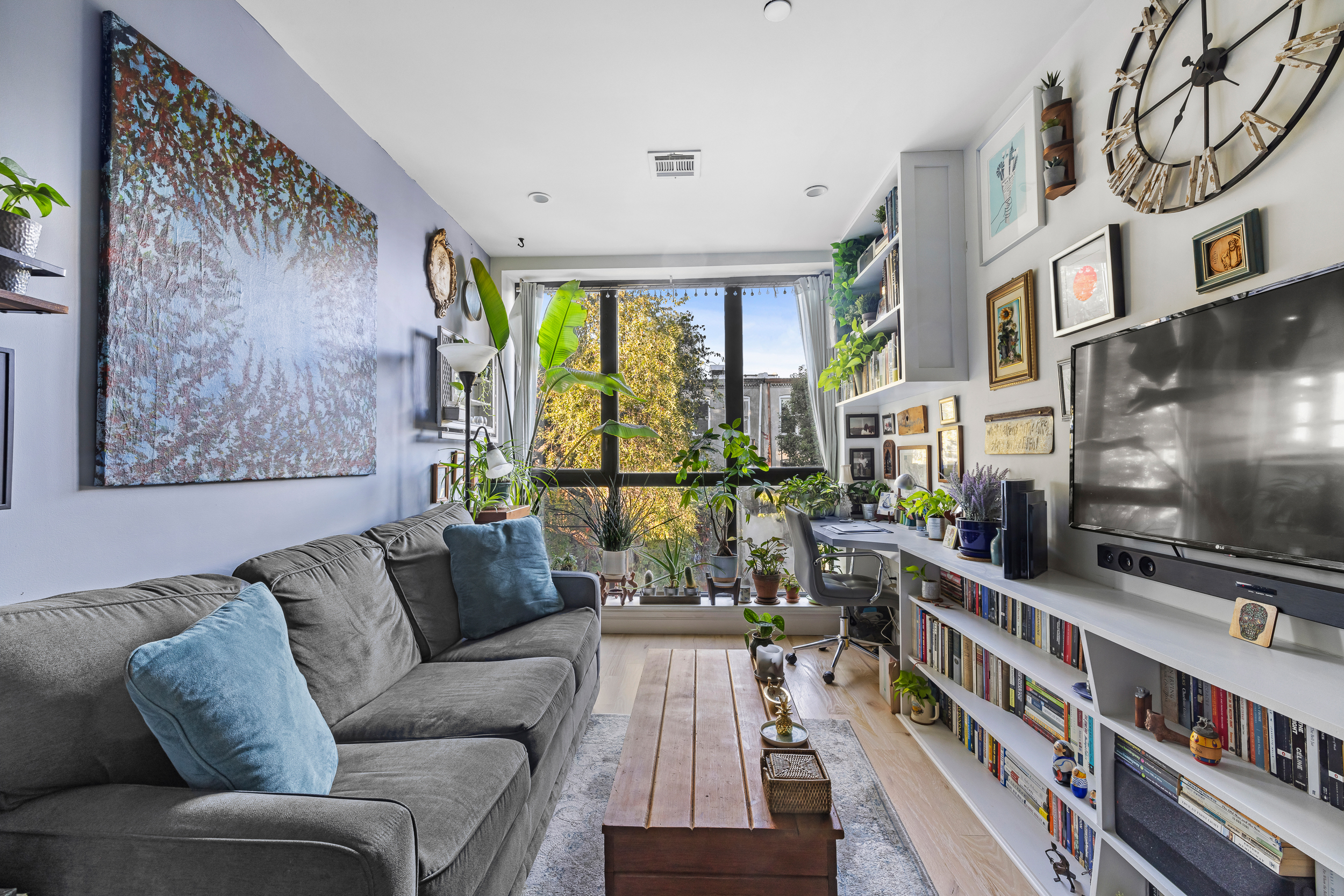 449 Decatur Street, Unit 3A Brooklyn, NY 11233 - Photo 2 of 9 a living room with furniture and a flat screen tv