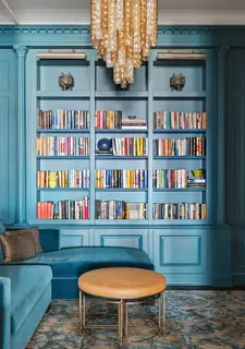 a view of a livingroom with furniture and bookshelf