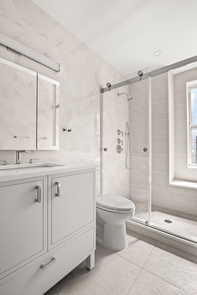 240 West End Avenue, Unit PH Manhattan, NY 10023 - Photo 23 of 25 a bathroom with a double vanity sink toilet and shower