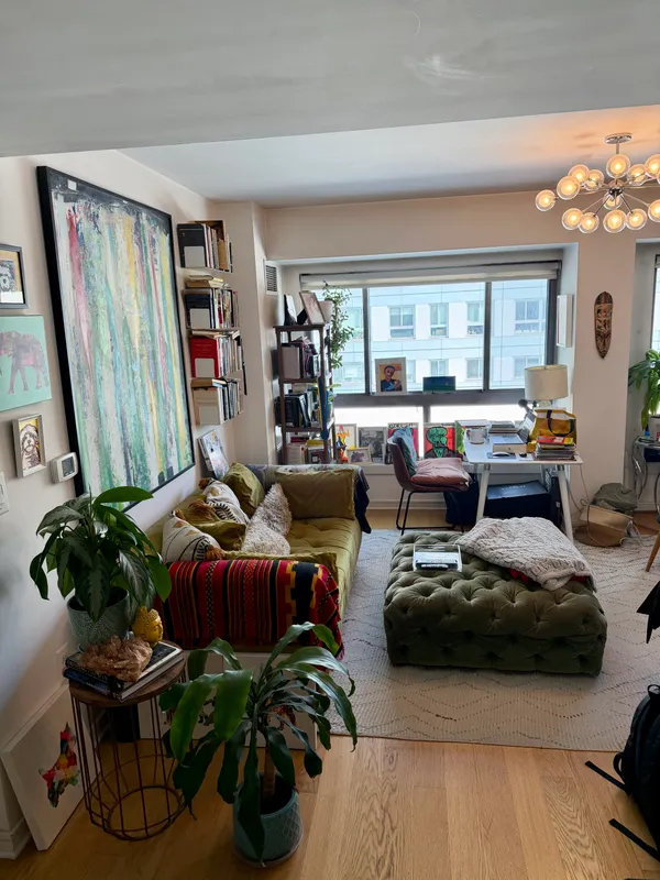 a living room with furniture fireplace and large window