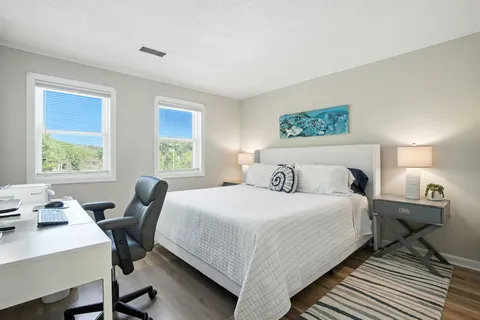 a bedroom with a bed and a table