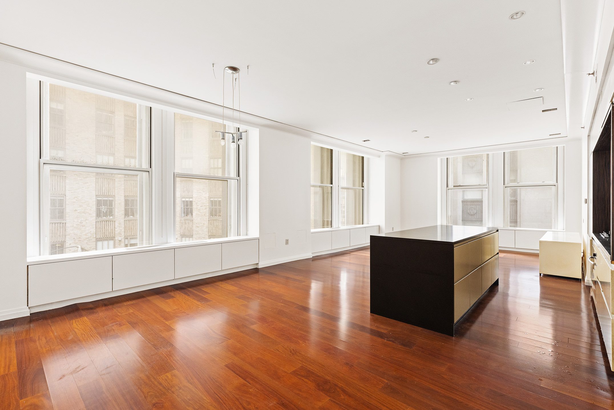 55 Wall Street, Unit 540 Manhattan, NY 10005 - Photo 3 of 10 a living room with couch and wooden floor