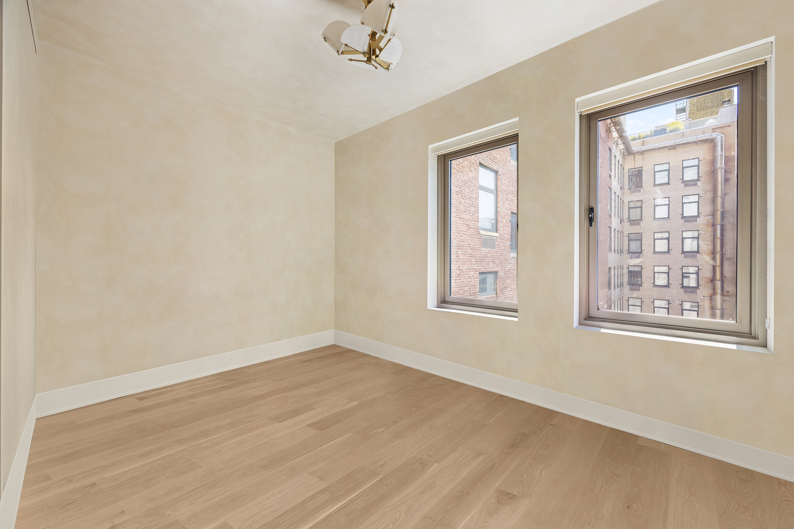 1 Great Jones Alley, Unit 10 Manhattan, NY 10012 - Photo 26 of 41 a view of an empty room with a window and wooden floor