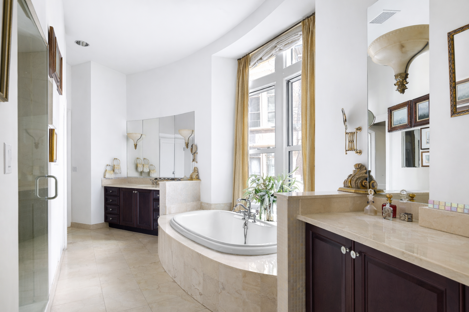 455 Central Park West, Unit 11 Manhattan, NY 10025 - Photo 7 of 18 a spacious bathroom with a granite countertop tub sink and mirror