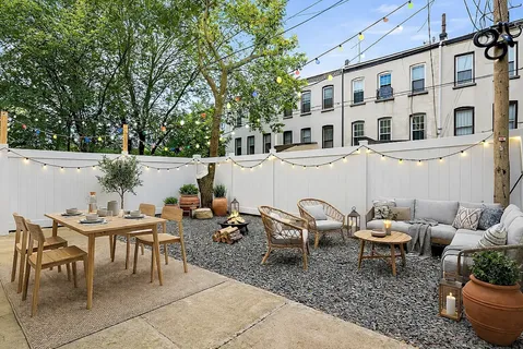 a view of a patio with table and chairs and potted plants