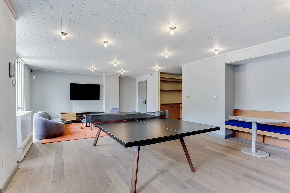 385 1st Avenue, Unit 10G Manhattan, NY 10010 - Photo 16 of 22 a living room with furniture and a flat screen tv