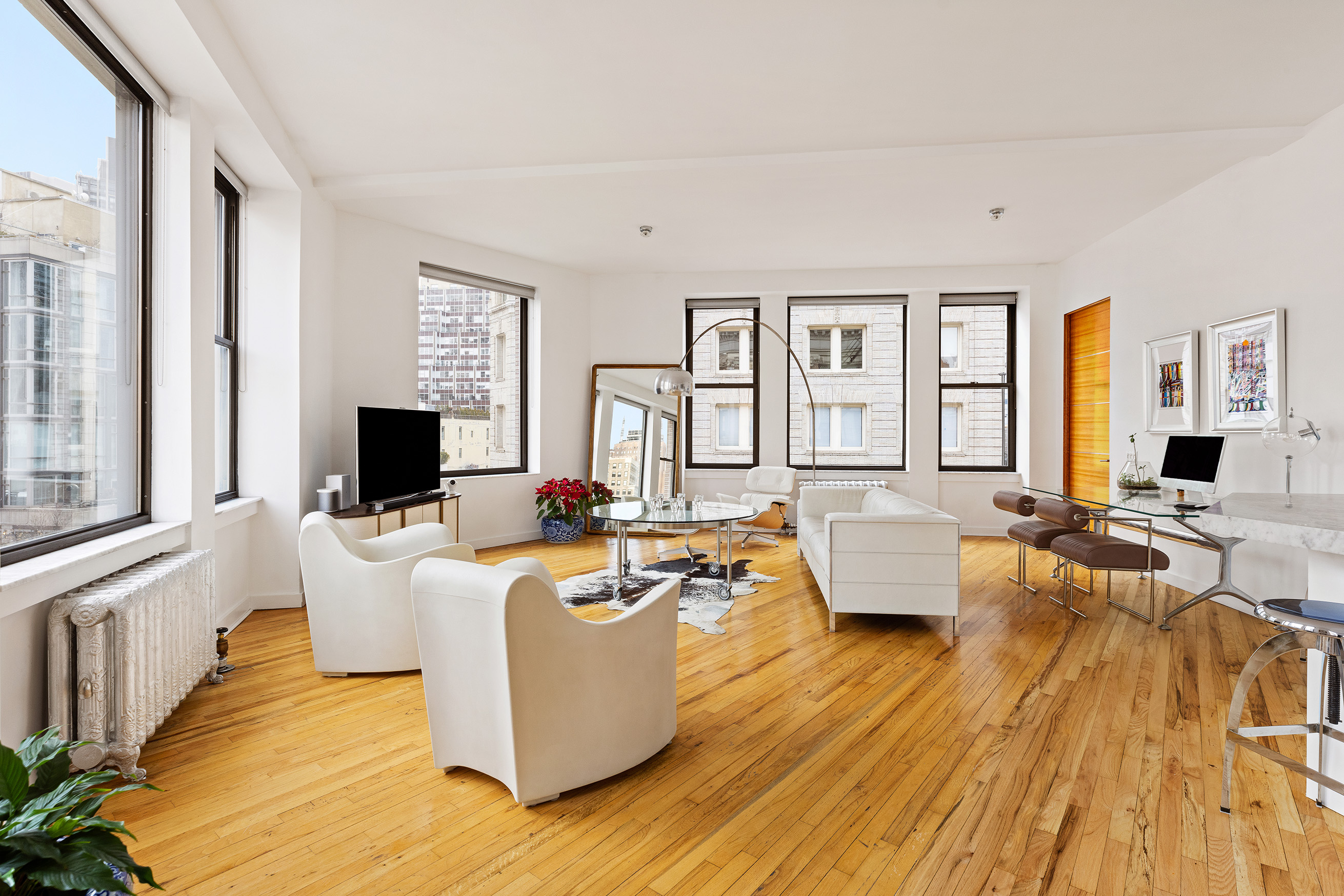 1 Hudson Street, Unit 9 Manhattan, NY 10013 - Photo 2 of 13 a living room with furniture and a flat screen tv