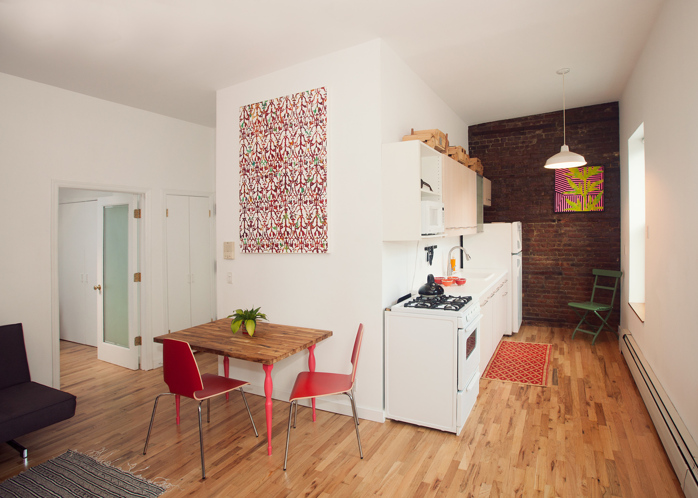 5-46 50th Avenue Queens, NY 11101 - Photo 15 of 17 a living room with furniture and a wooden floor