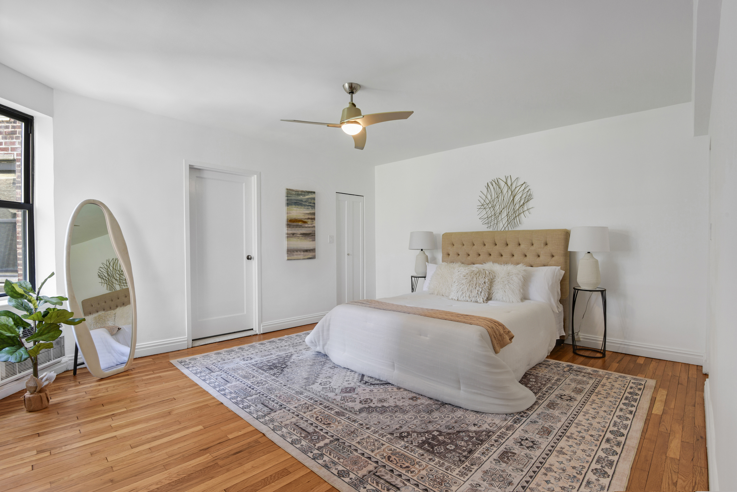 330 East 70th Street, Unit 4F Manhattan, NY 10021 - Photo 8 of 14 a bedroom with a bed dresser and a wooden floor