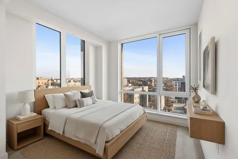 a bedroom with a large bed and a large window