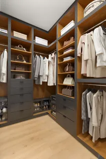 a view of walk in closet with clothes and shoes