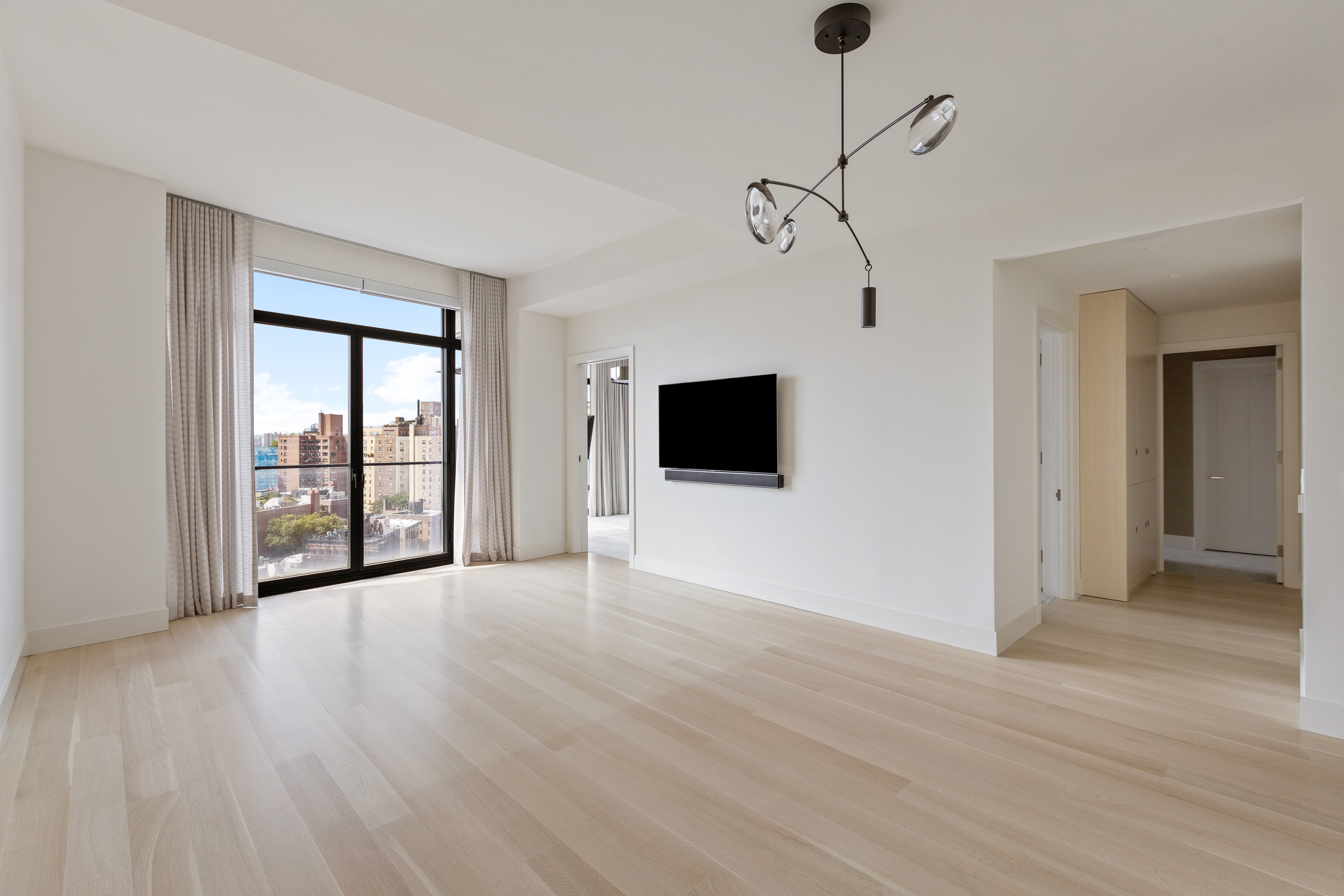 155 West 11th Street, Unit 14D Manhattan, NY 10011 - Photo 2 of 12 a view of an empty room with wooden floor and a window