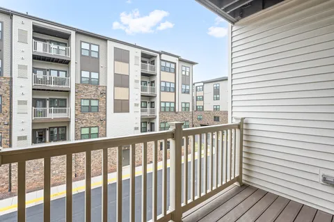 a view of a balcony with wooden floor