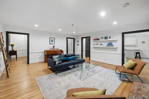a kitchen with stainless steel appliances granite countertop white cabinets and a stove a refrigerator with white cabinets