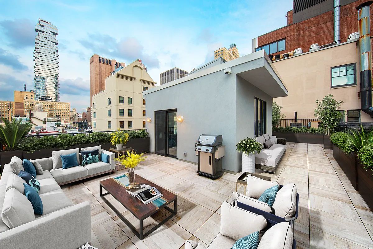 45 Warren Street, Unit PH Manhattan, NY 10007 - Photo 17 of 29 a view of a patio with couches table and chairs and potted plants