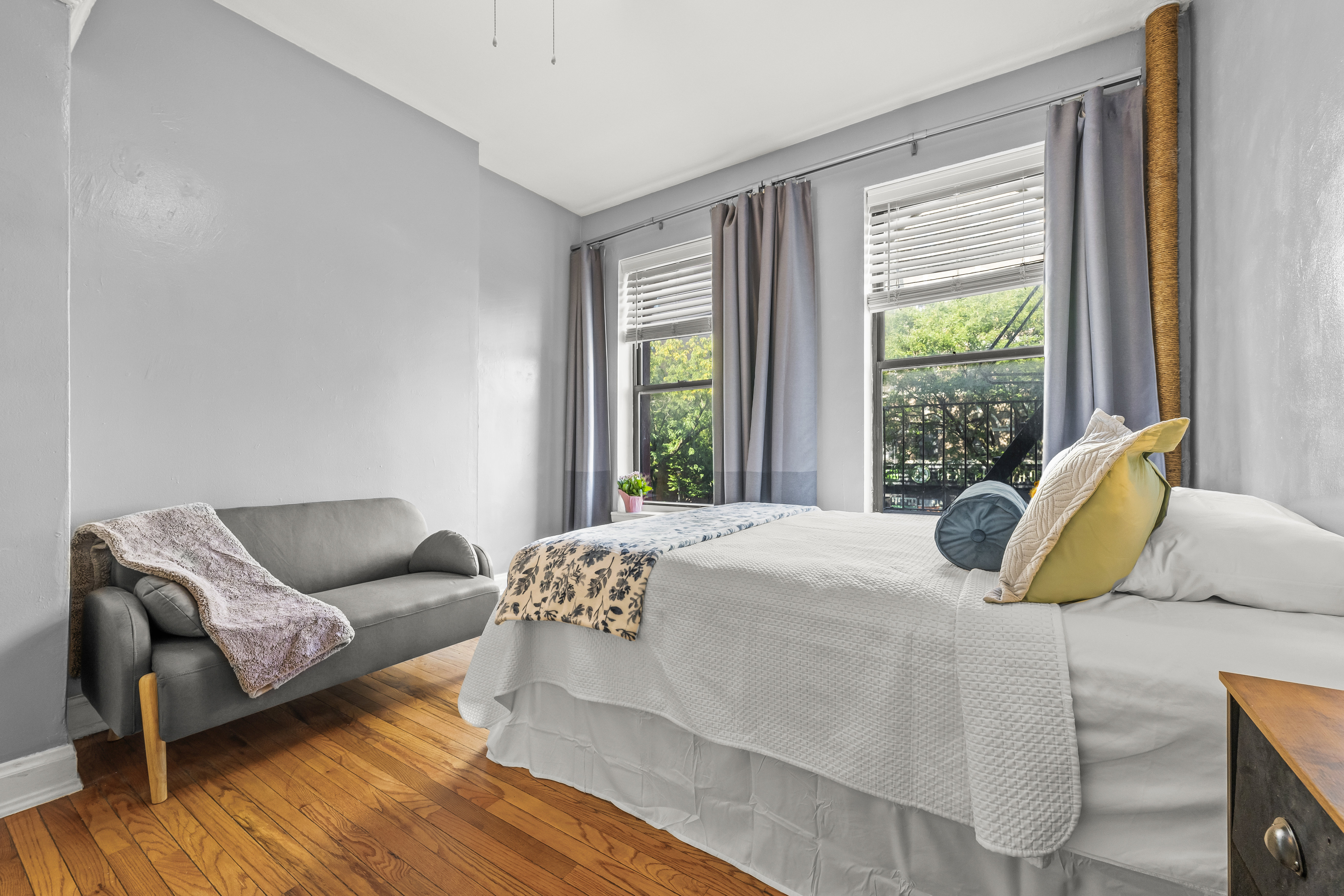 1777 Madison Avenue, Unit 24 Manhattan, NY 10035 - Photo 8 of 20 a bedroom with a bed and wooden floor