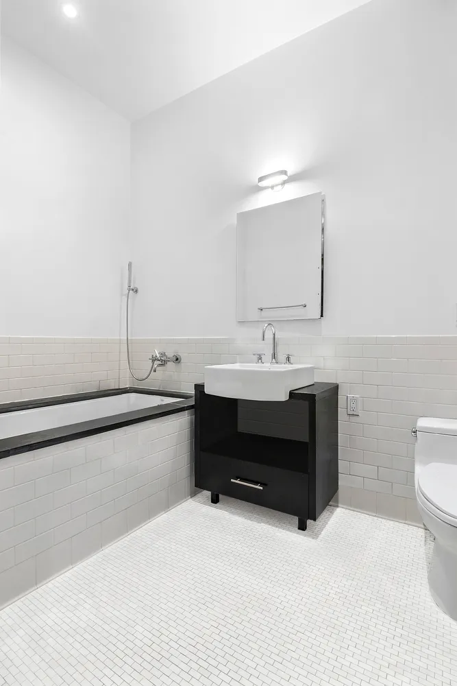 a bathroom with a sink toilet and vanity