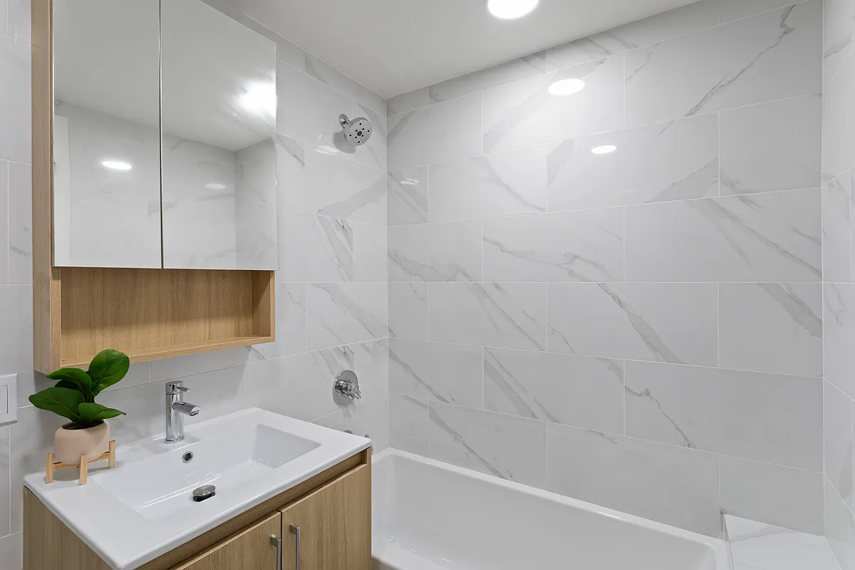 3112 Emmons Avenue, Unit 305 Brooklyn, NY 11235 - Photo 4 of 9 a bathroom with a sink a toilet and shower