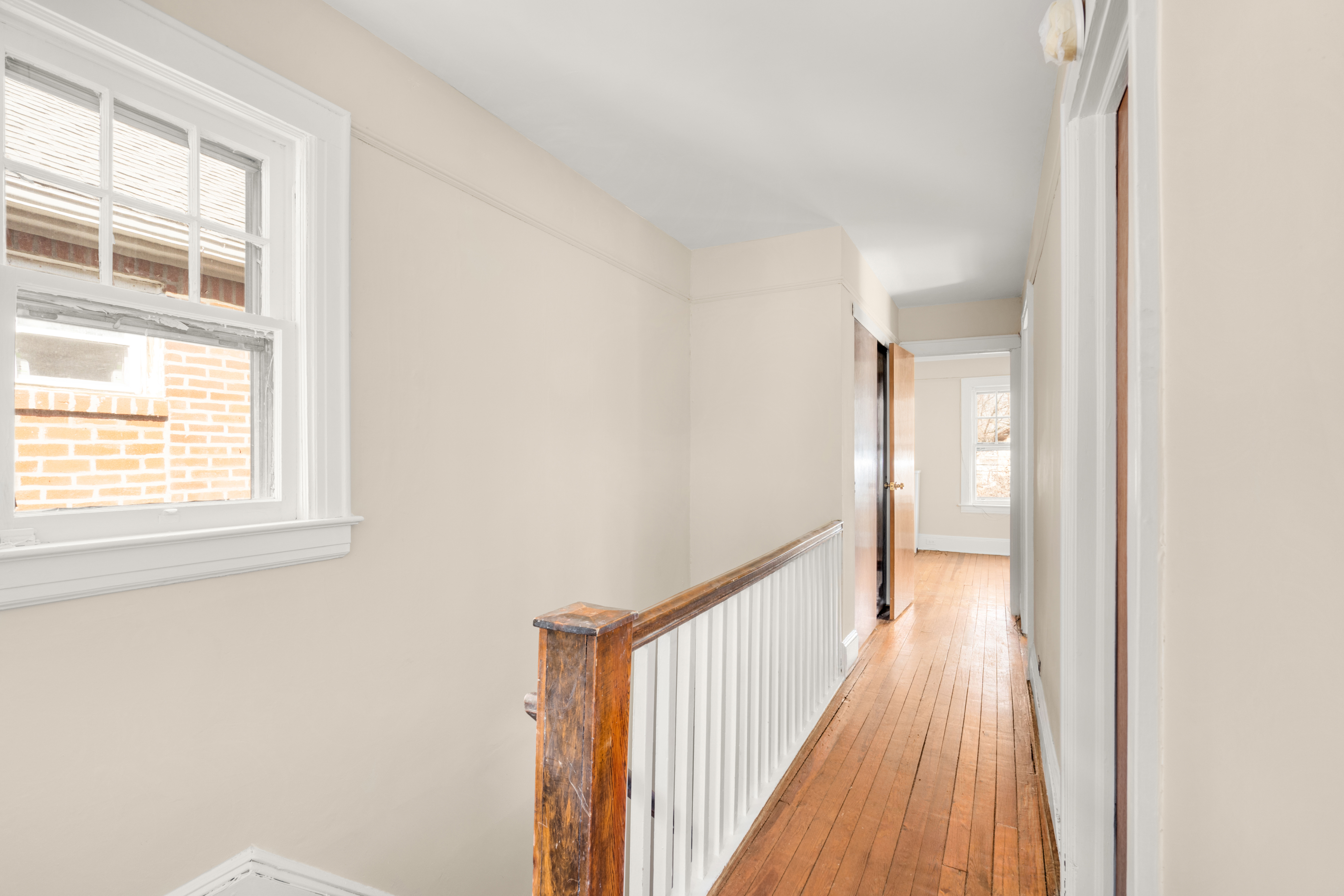 107-28 118th Street Queens, NY 11419 - Photo 9 of 12 a view of a room with a wooden floor and windows