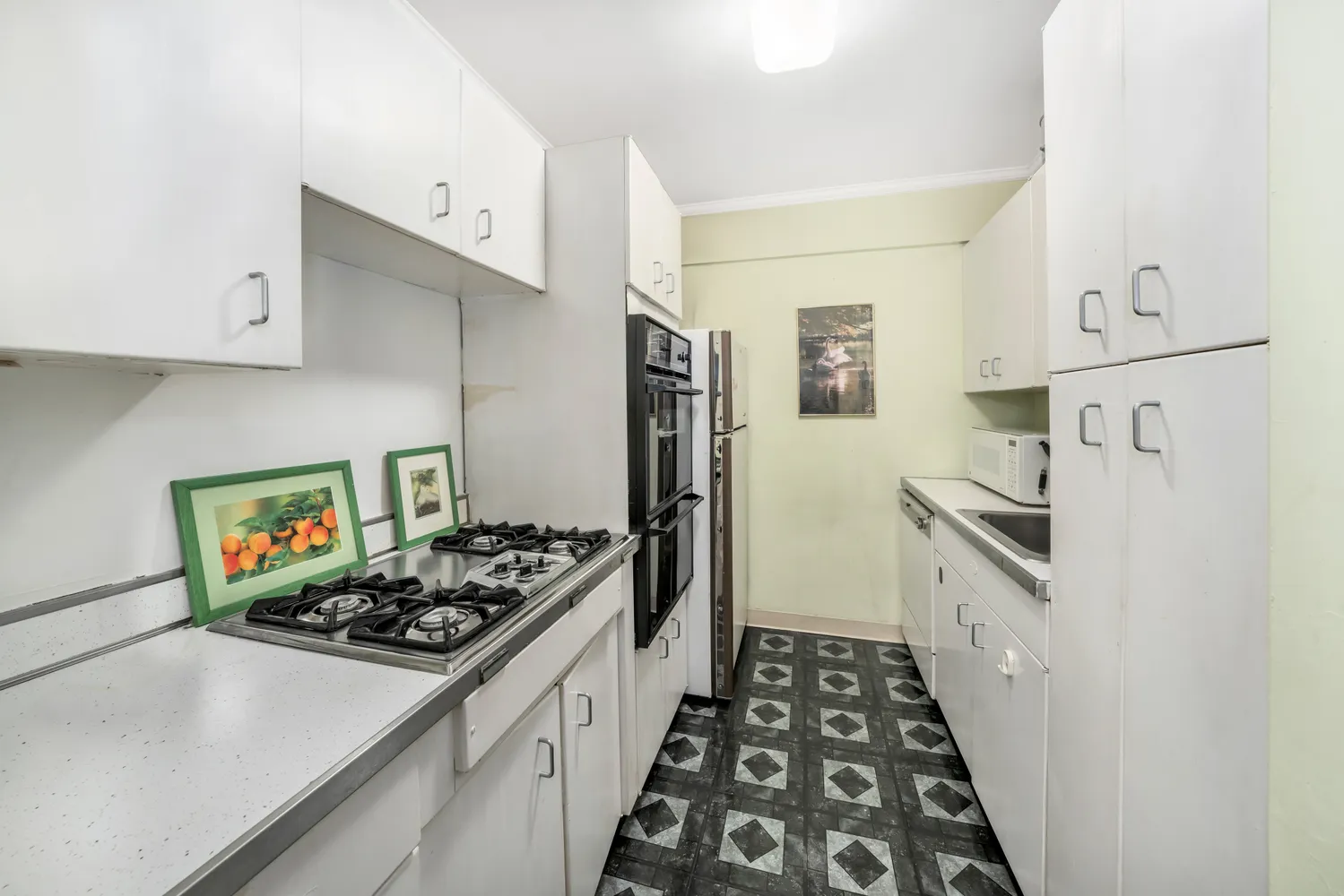 a kitchen with stainless steel appliances a stove a sink and a refrigerator
