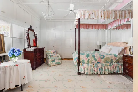 a bedroom with furniture and a chandelier