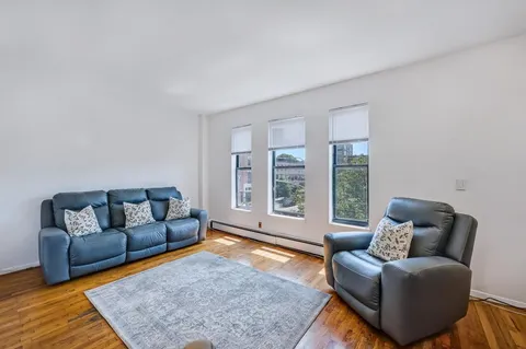 a living room with furniture and a rug