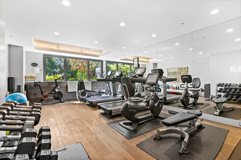 a room with gym equipment and a large window