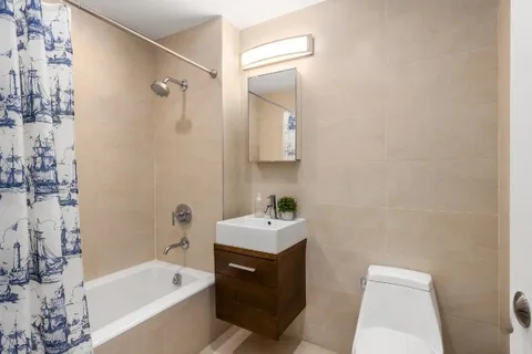 a bathroom with a sink toilet tub and shower