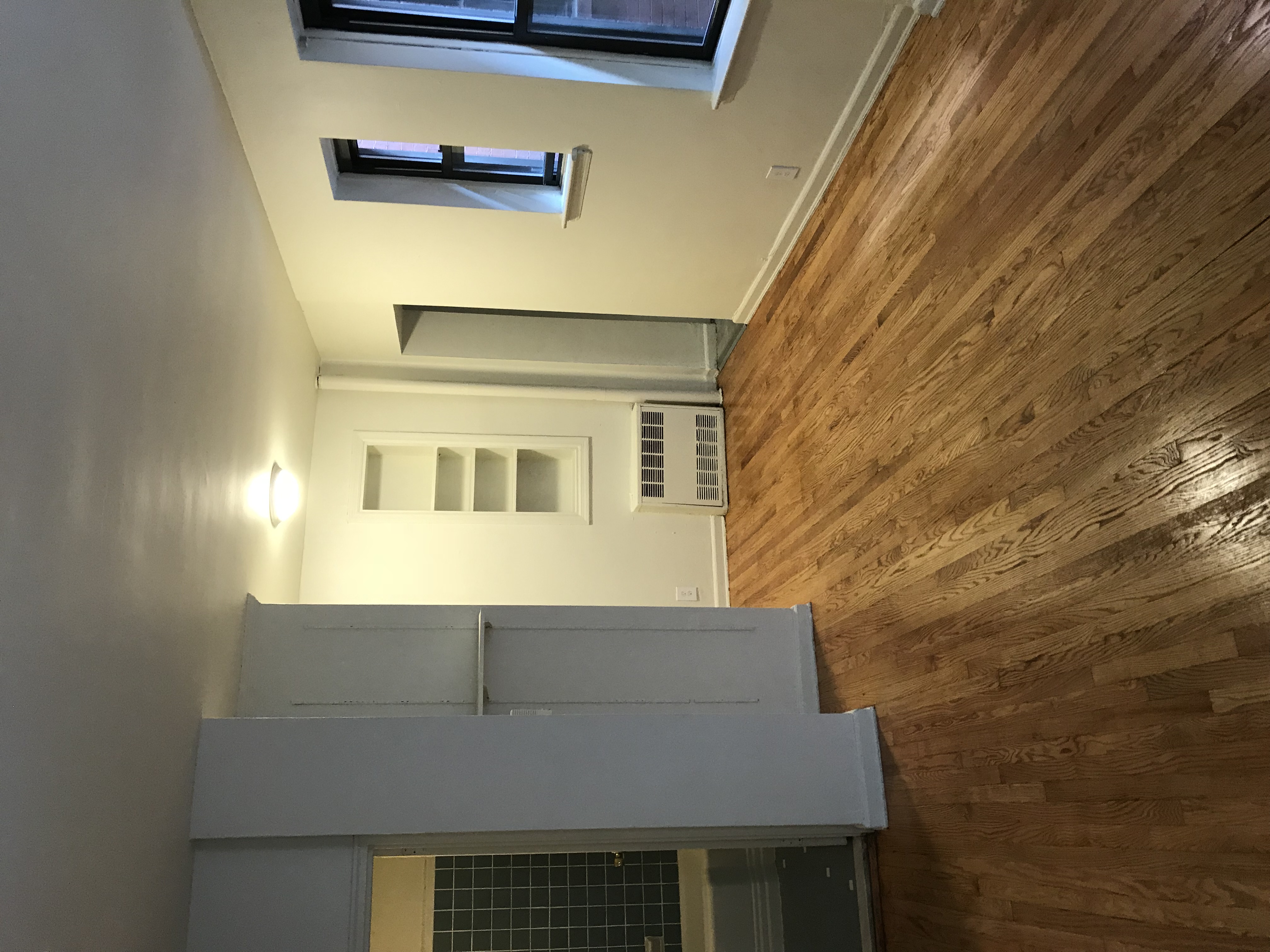 151 East 43rd Street, Unit 4B Manhattan, NY 10017 - Photo 7 of 7 a view of empty room with wooden floor