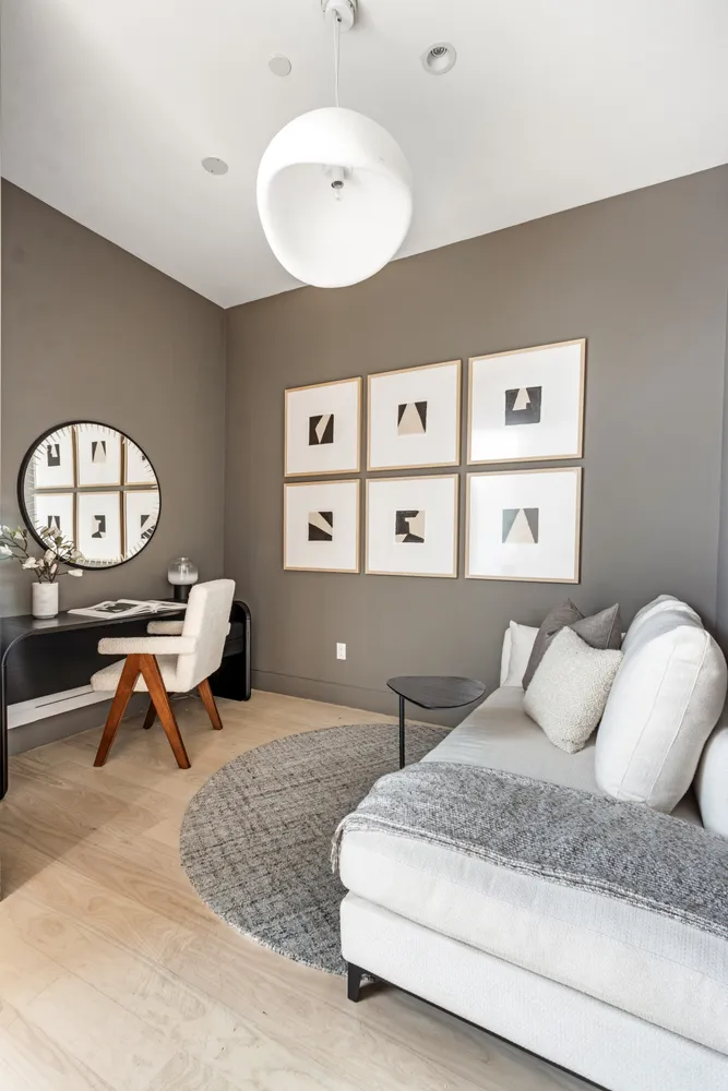 a living room with furniture and a large mirror