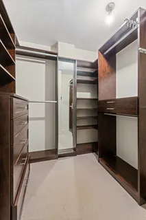a view of walk in closet with empty racks