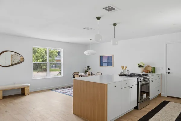a kitchen with a sink and a stove top oven
