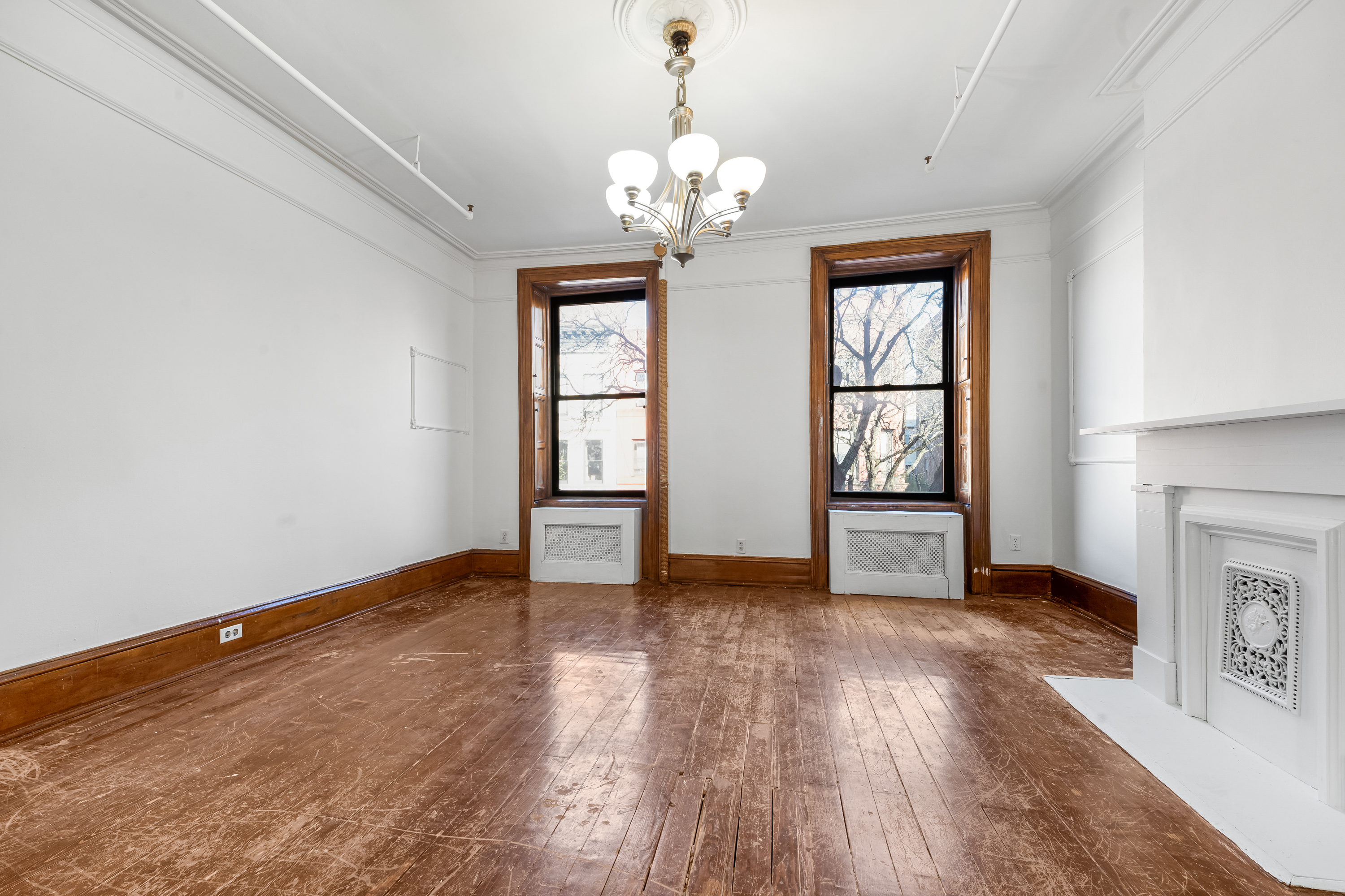 458 West 153rd Street Manhattan, NY 10031 - Photo 12 of 21 a view of livingroom with window and hardwood floor