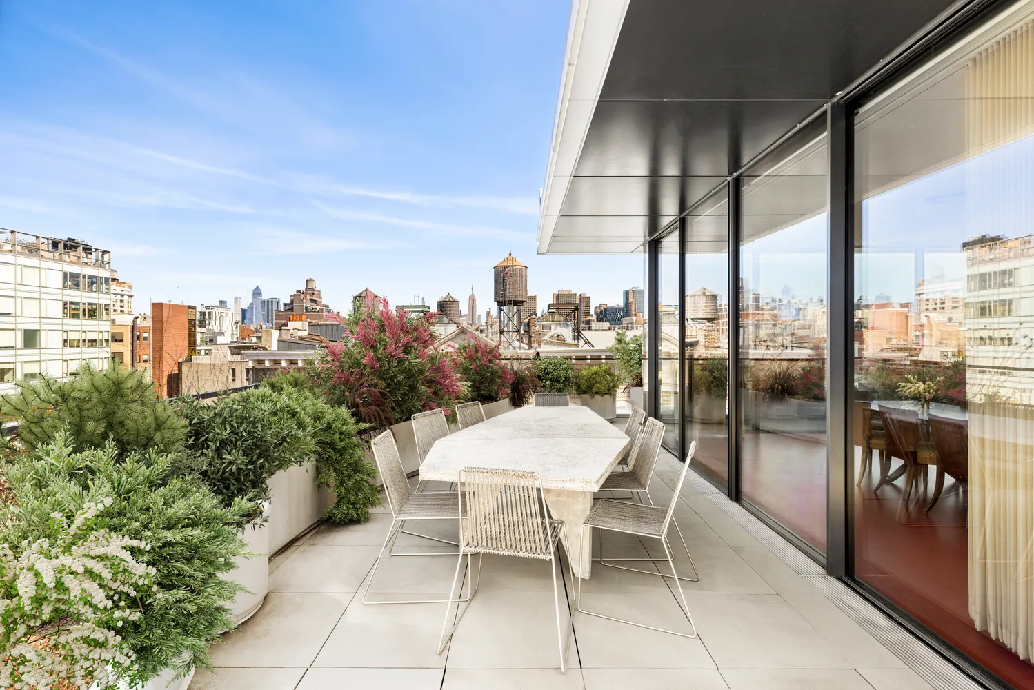 a view of a terrace with furniture and floor to ceiling window