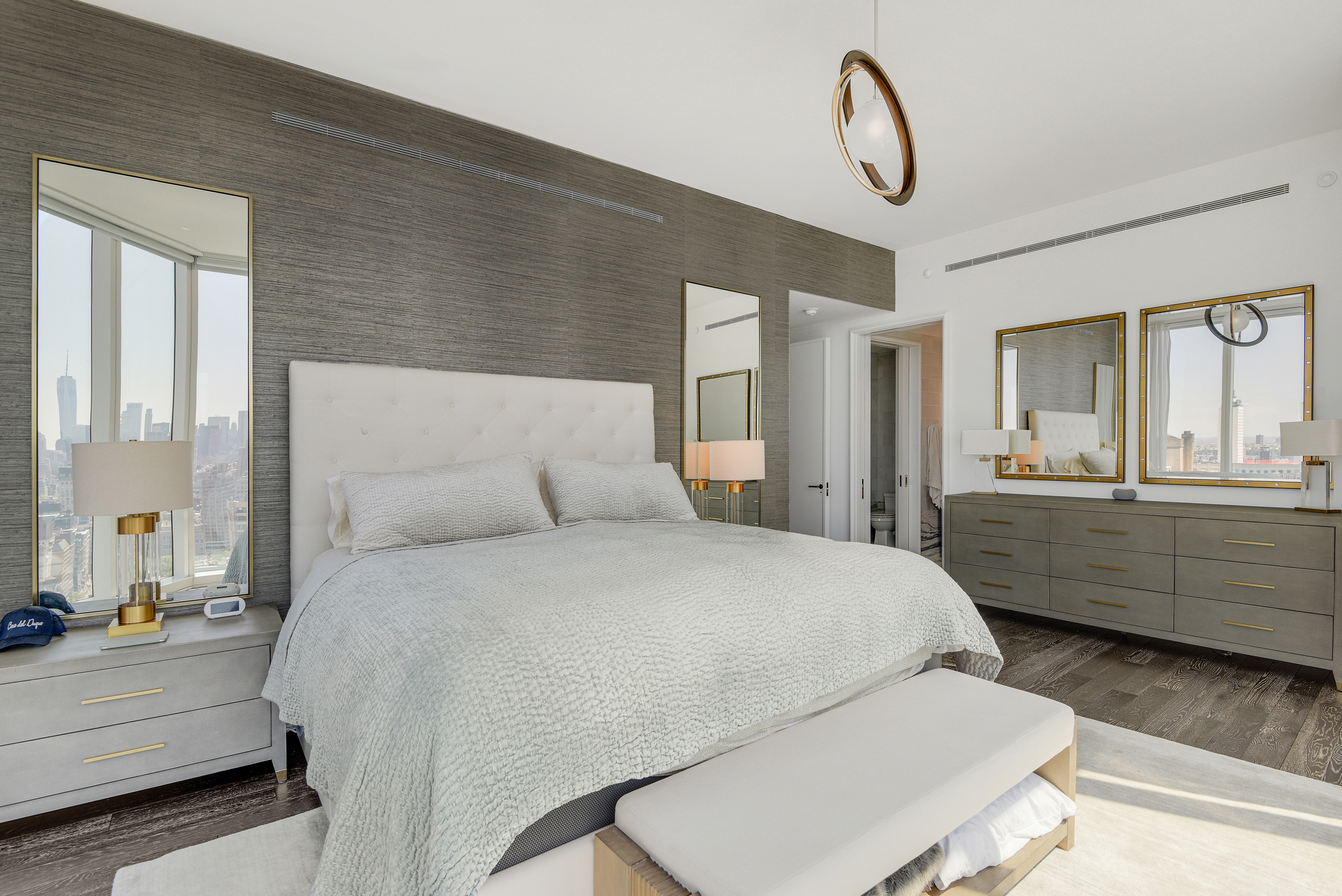 45 East 22nd Street, Unit 34A Manhattan, NY 10010 - Photo 7 of 24 a bedroom with a bed a chandelier and dresser