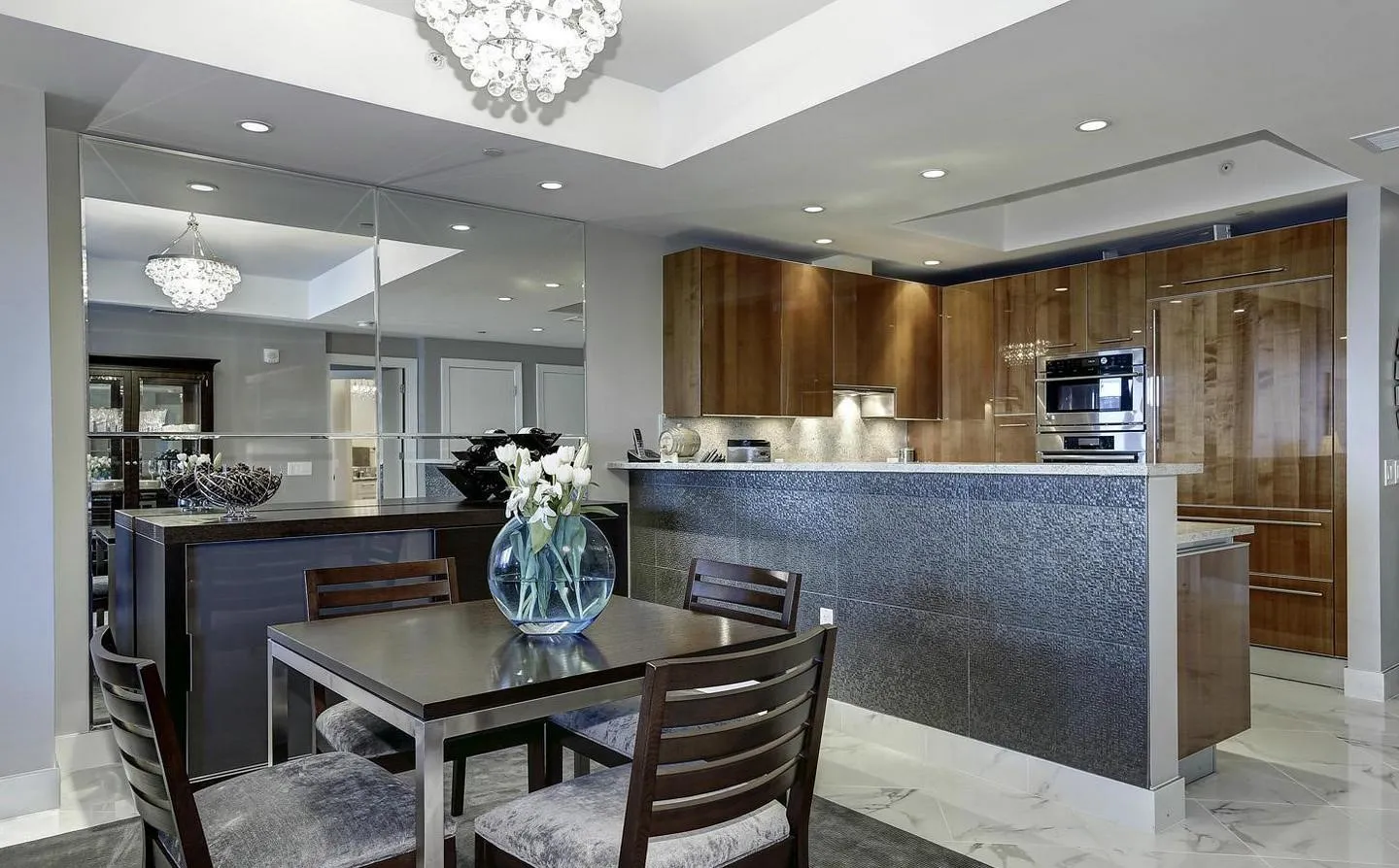 a kitchen with kitchen island granite countertop a table and chairs in it