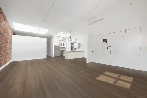 a view of a kitchen with wooden floor