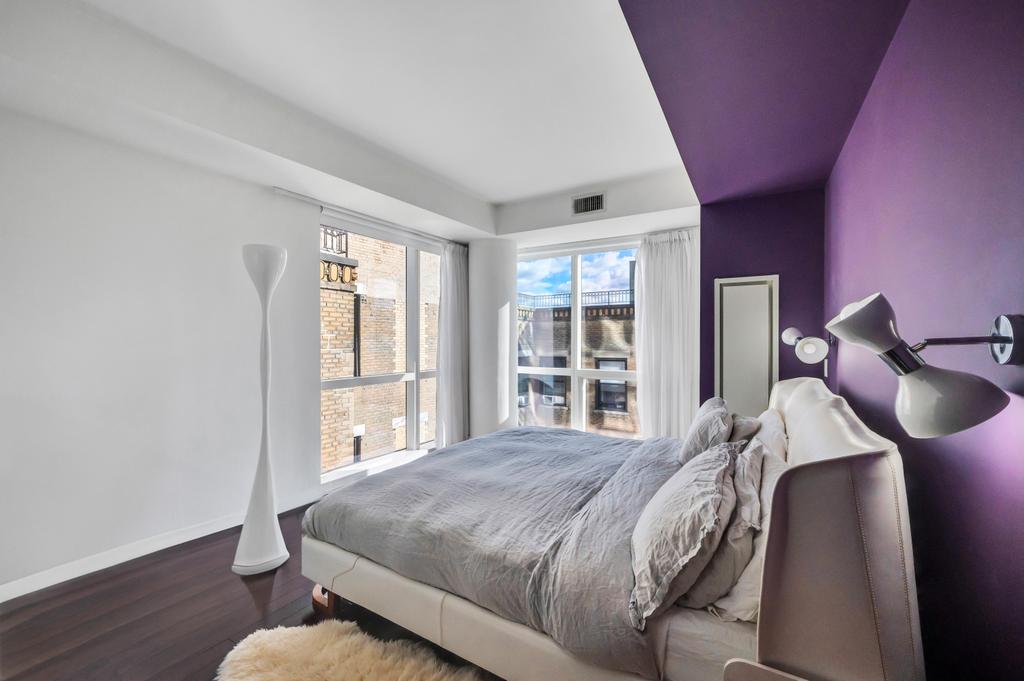 2628 Broadway, Unit 15B Manhattan, NY 10025 - Photo 6 of 22 a bedroom with a bed and wooden floor